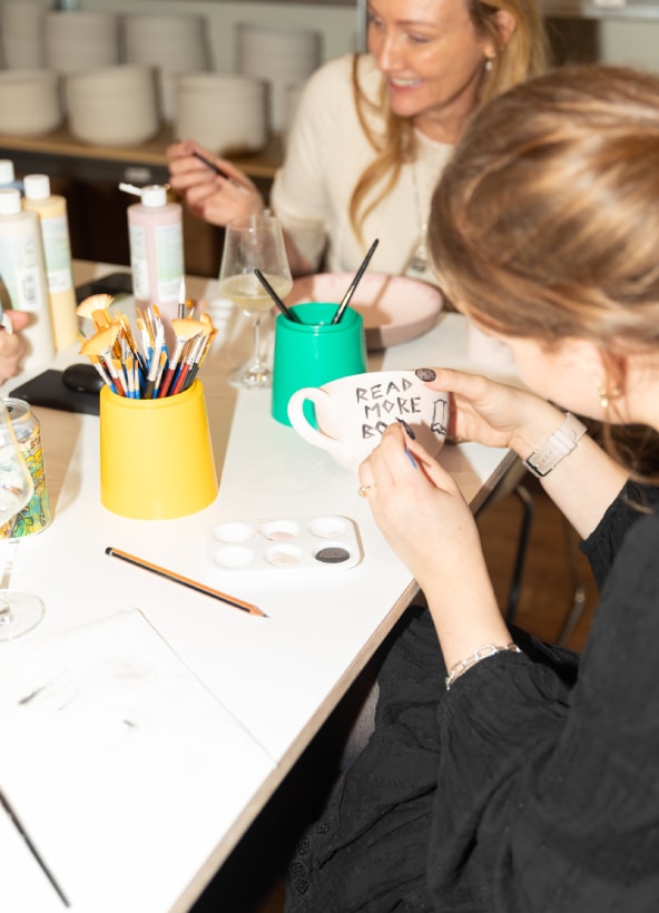 Person painting cup